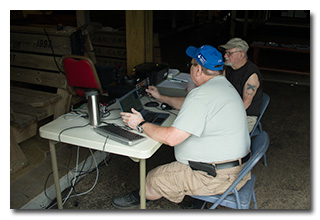 Jeff Slattery, N8SUZ, operates HF SSB, while Bob Moore, KC8KSM, watches