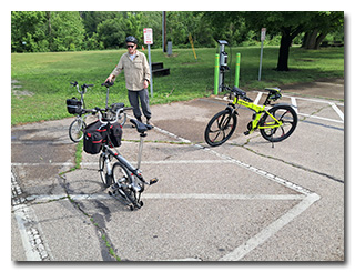 Tom standing with three folding bicycles