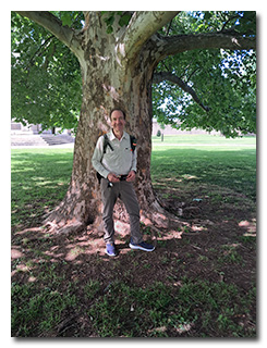 Len standing in front of a huge old maple tree