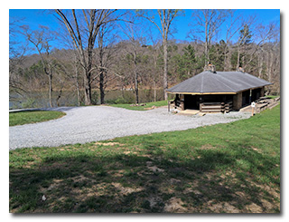 a picnic shelter on the edge of a lake