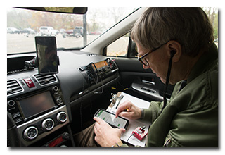 a radio operator typing on a smartphone