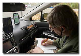 a man operating a radio in a car