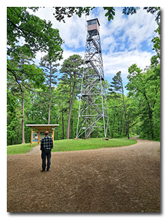 Tom stands under the fire tower