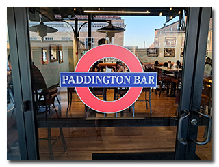 The Paddington Bar sign, depicted as the sign for the genuine Paddington Station sign in London