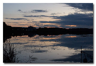 The Goodyear blimp hanger in late evening light viewed over Wingfoot Lake